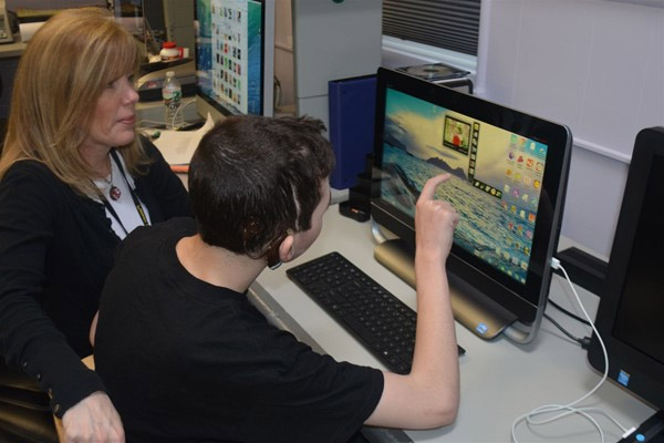 NJEDDA High School student working with teacher at desktop computer - private special education school