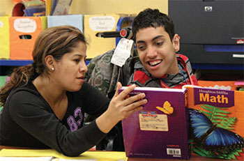 Male NJEDDA high school student working on reading with female teacher = private special education school in Passaic NJ