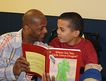 NJEDDA High School Teacher reading with male student at private special education school in Clifton NJ