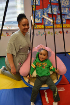 Young male student in physical therapy swing at NJEDDA Passaic NJ - private special education school