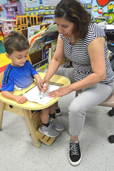 Female teacher working with young male NJEDDA Preschool student - private special education school