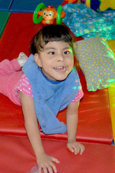 Female NJEDDA preschool student on gym mats with sensory stimulation lights
