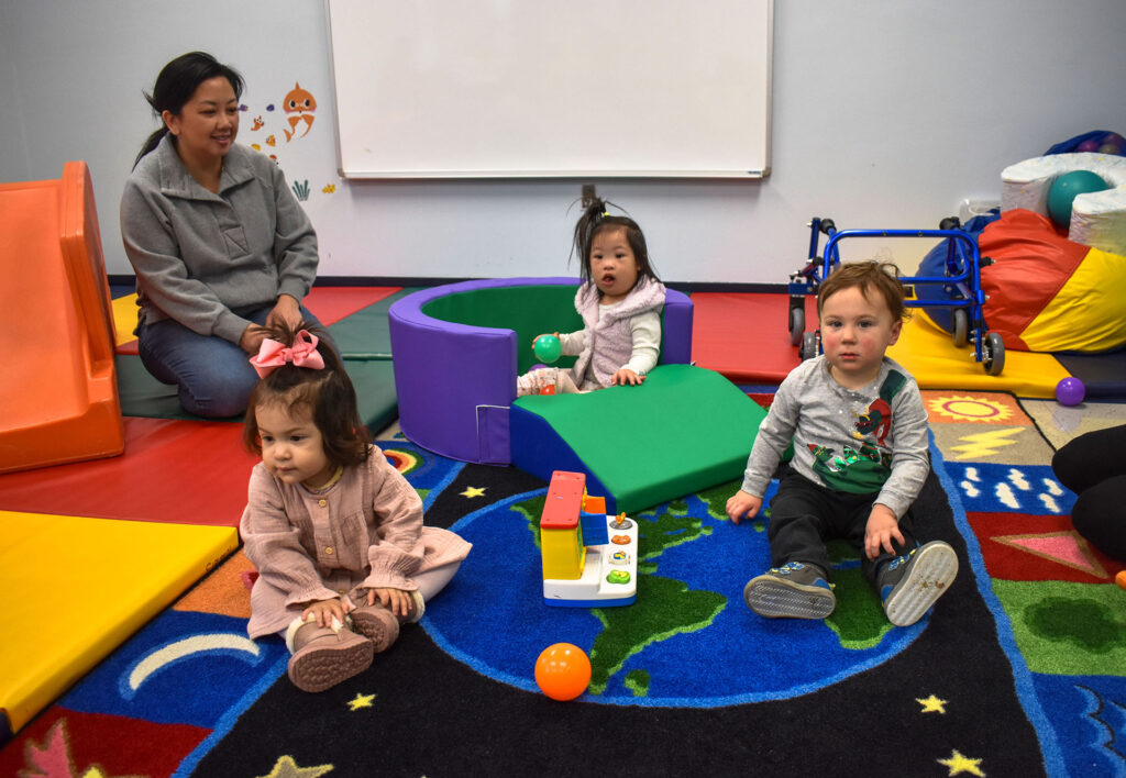 Three toddlers and a teacher in NJEDDA's Toddler classroom