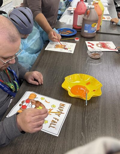 A group of NJEDDA Adult Training Center participants making Thanksgiving gift cards at the agency's center.