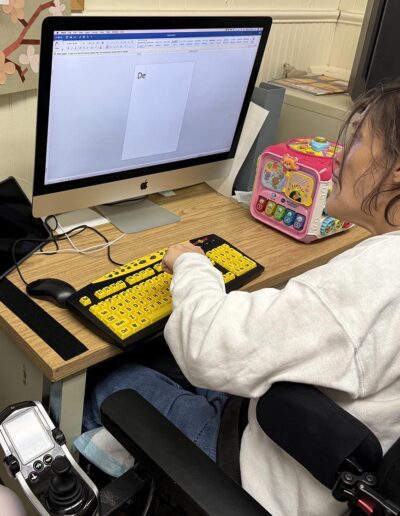 A female NJEDDA Adult Training Center participant working on computer skills.