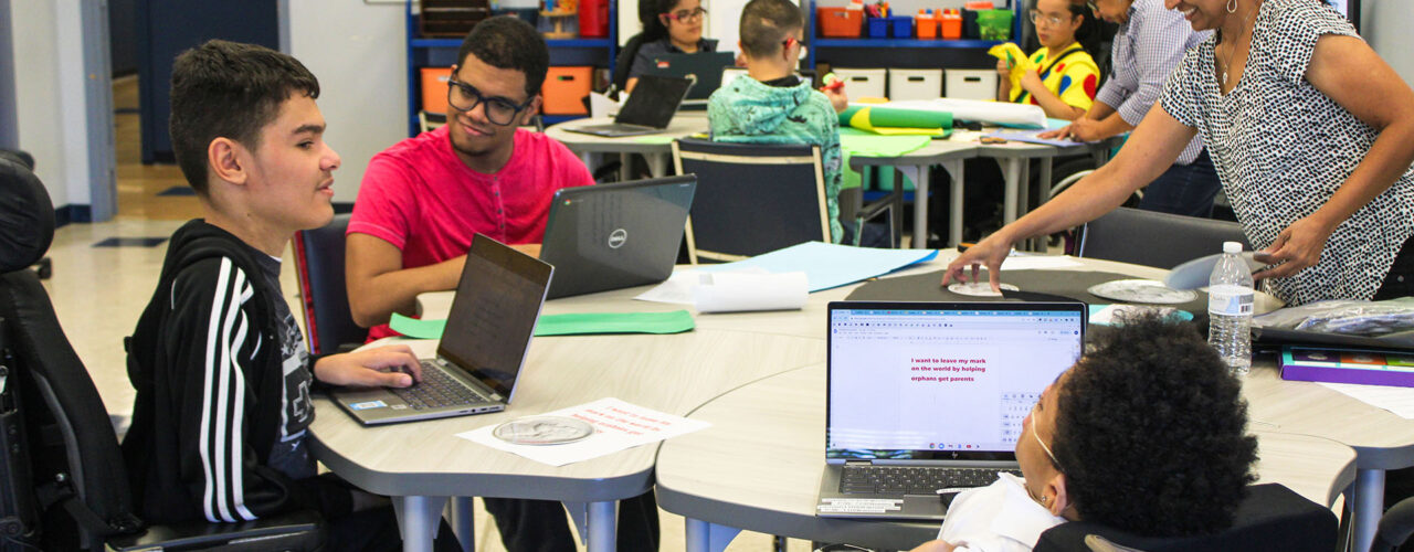 Several NJEDDA High School students working around center-facing desks.